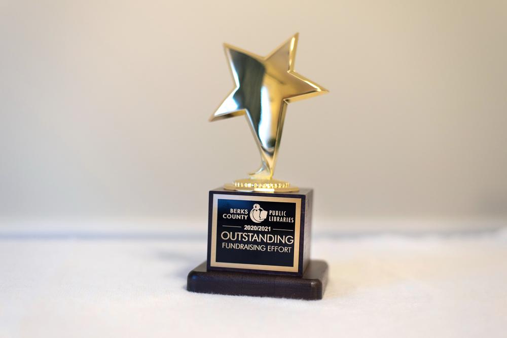 golden star trophy with fundraising effort engraving