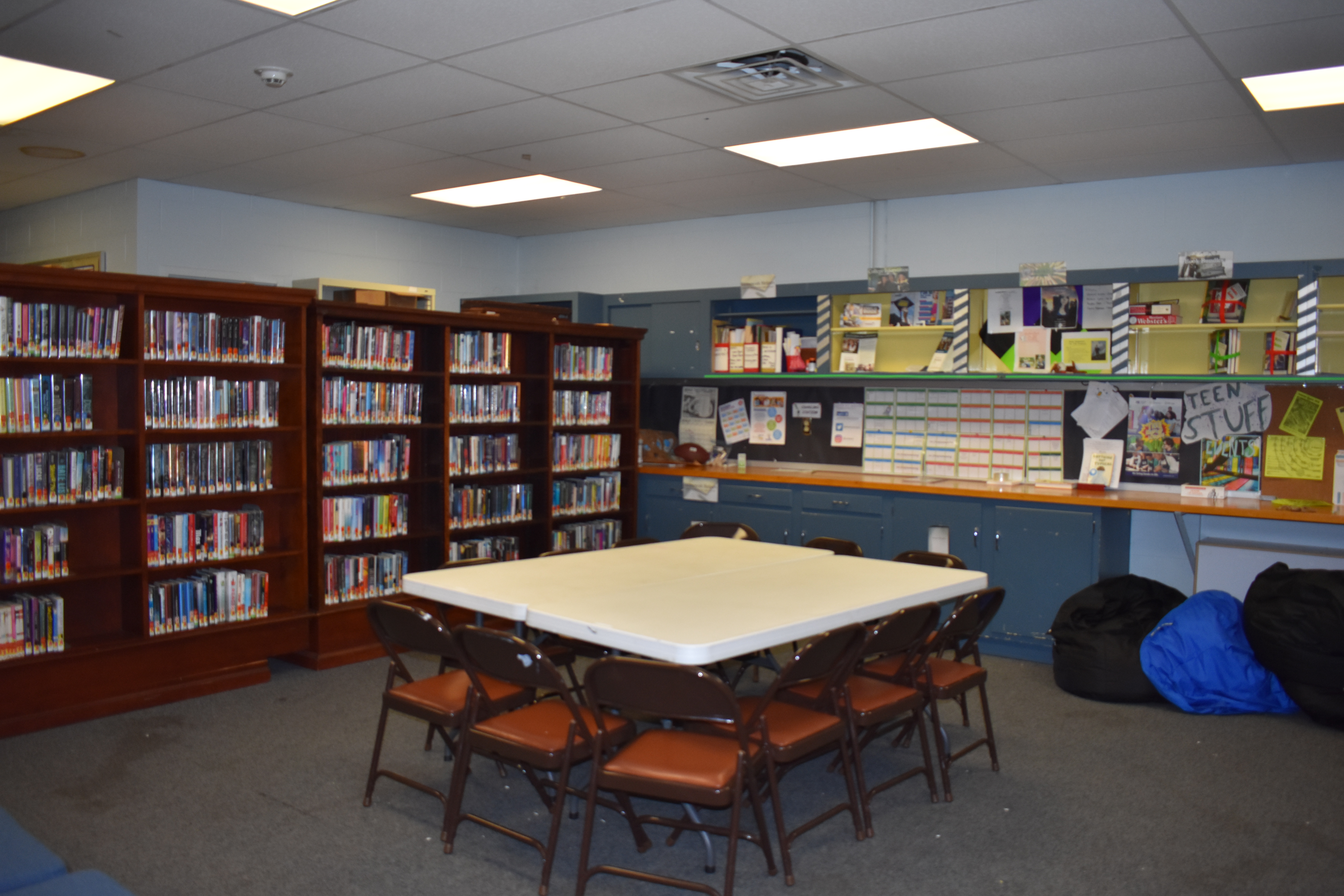 Photo of Teen Room with tables, chairs, bookshelves, etc.