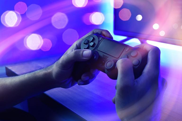 artistic shot of person holding video game controller