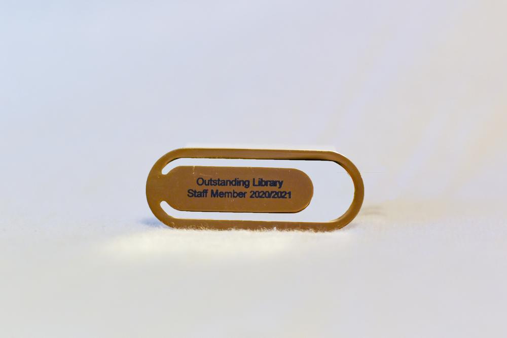 golden bookmark with library staff member engraving