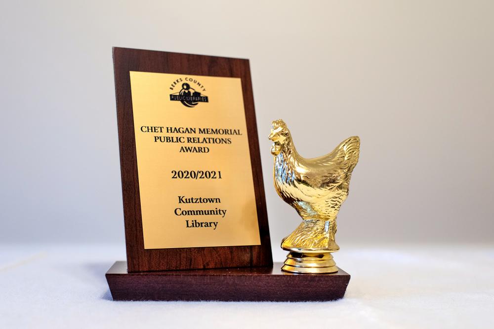 plaque stand with golden chicken trophy