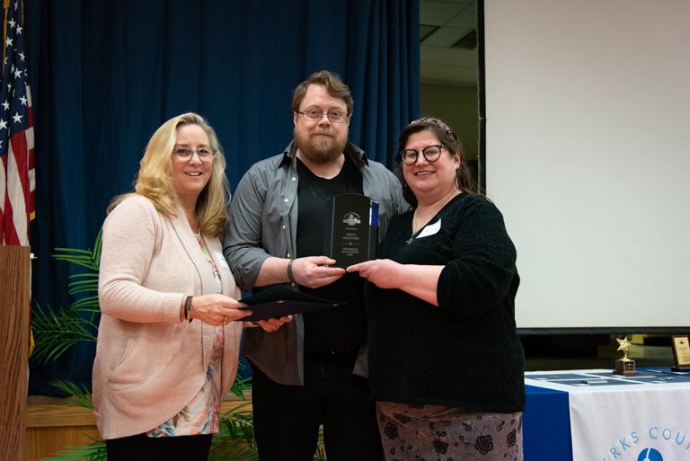 Winners Matthew Williams and Rebecca Laincz accept the Outstanding Business award from BCPL Advisory Board member Debbie.