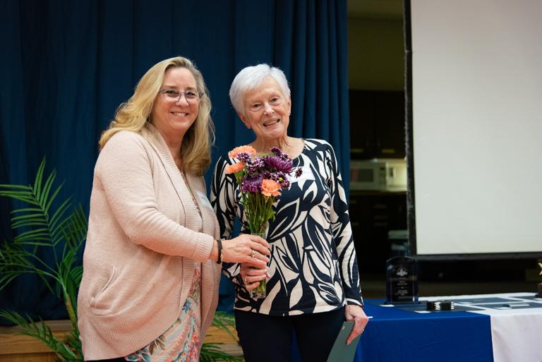 BCPL Board member Debbie presents the Friend of the Year vase and flowers to winner Annette Heffelfinger.