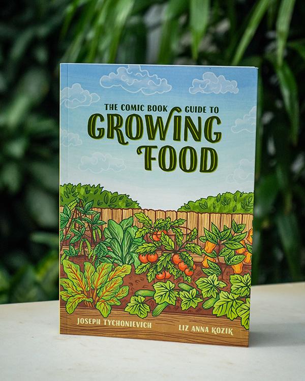Growing Food book in front of green, leafy outdoor scene