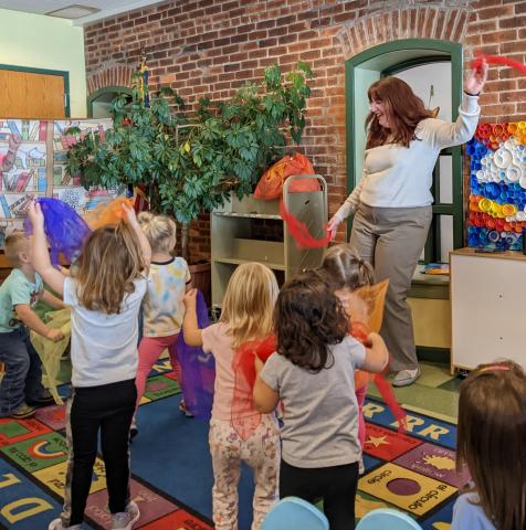 Children dance with scarves at Storytime.