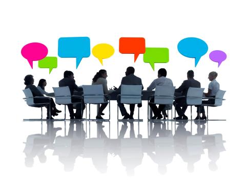 silhouette of people sitting around a table with empty colored speech bubbles above them