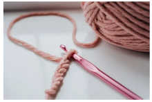 pink yarn and crochet hook