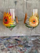 Two wineglasses with sunflowers painted on