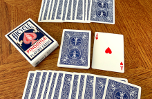 A pinochle deck of cards laid out on a table.