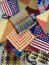 A variety potholders of different designs splayed out
