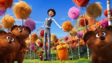 the lorax with the onceler and tiny bears with truffula trees in the background